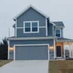 a two-story house painted dove gray with white trim.
