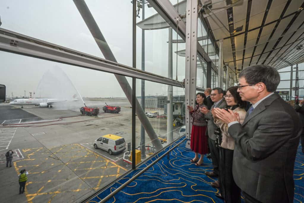 The C919 aircraft receives a water salute at Hong Kong International Airport and warm welcome by Secretary for Transport and Logistics Mable Chan