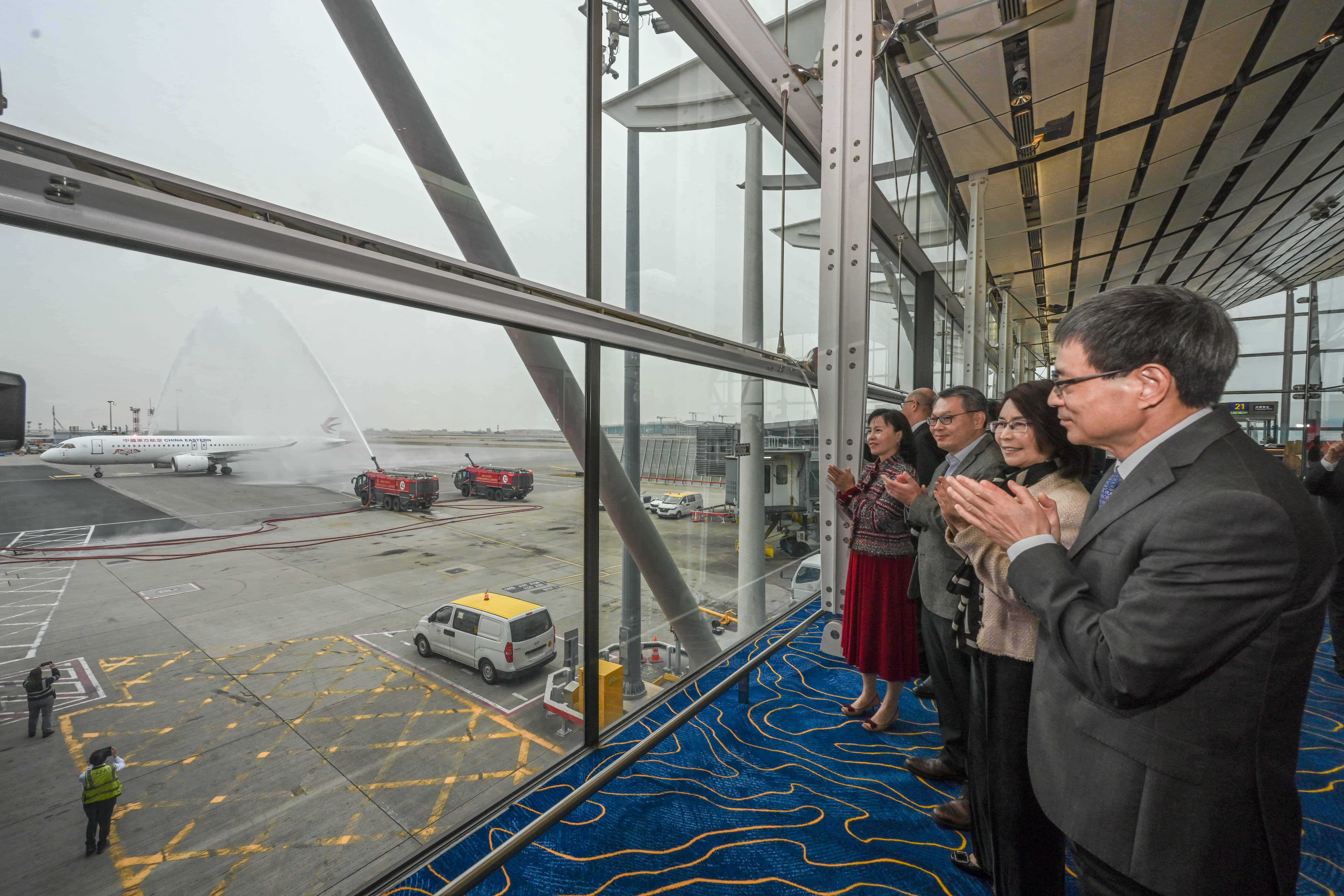 The C919 aircraft receives a water salute at Hong Kong International Airport and warm welcome by Secretary for Transport and Logistics Mable Chan