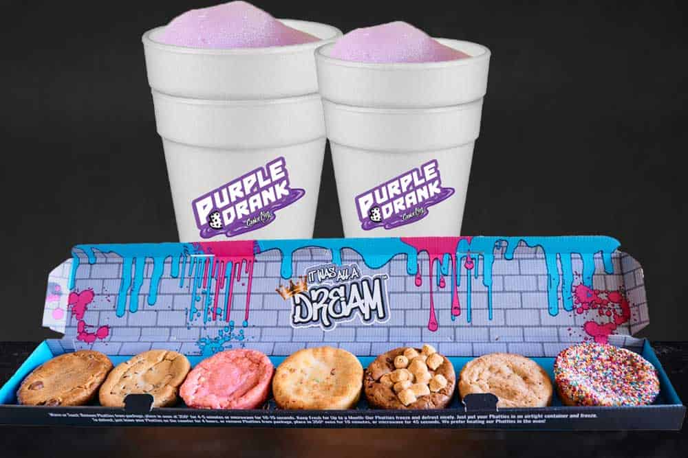 a large cookie box that holds 7 thick cookies in various flavors like sprinkled sugar cookie, strawberry, chocolate chip, and more with two large cups with purple sleet that says 'Purple Drank'.