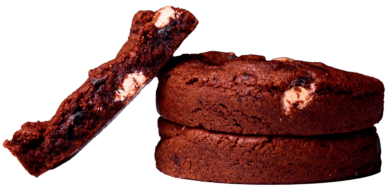 Thick stack of four red velvet cake cookies with white chocolate chips.