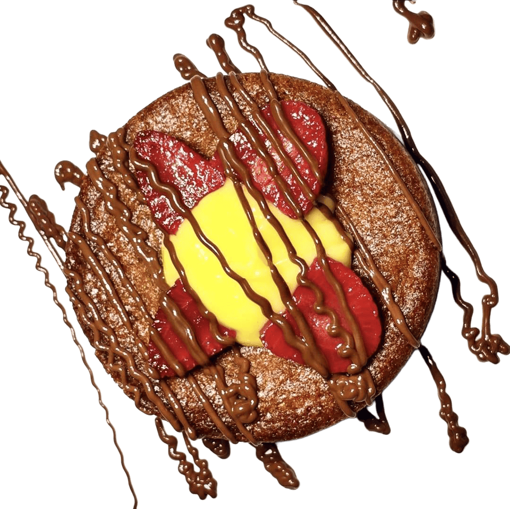 Large filled cookie with a yellow banana filled cookie with chocolate and sliced strawberries