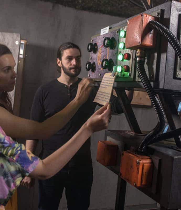 A man and woman standing next to a machine.