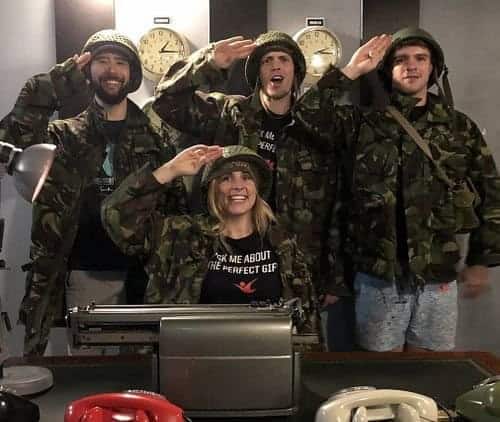 Four people in military uniforms posing for a photo.