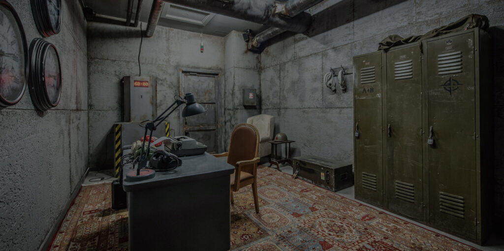 A room with a desk, a locker and a chair.