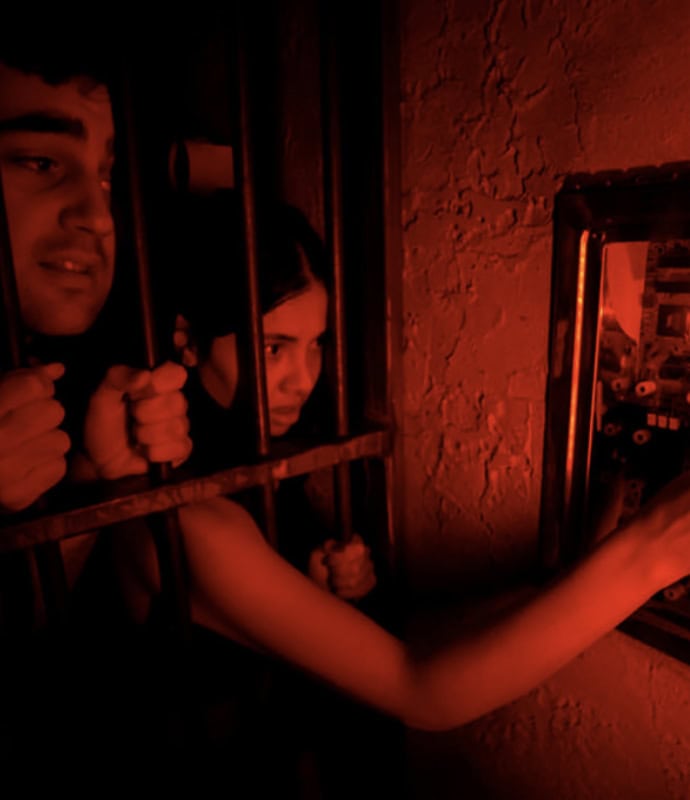 A man and woman in a jail cell.