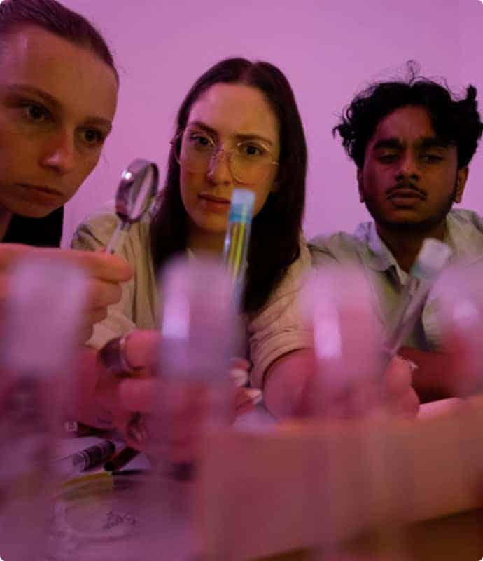 Three students working in a lab.