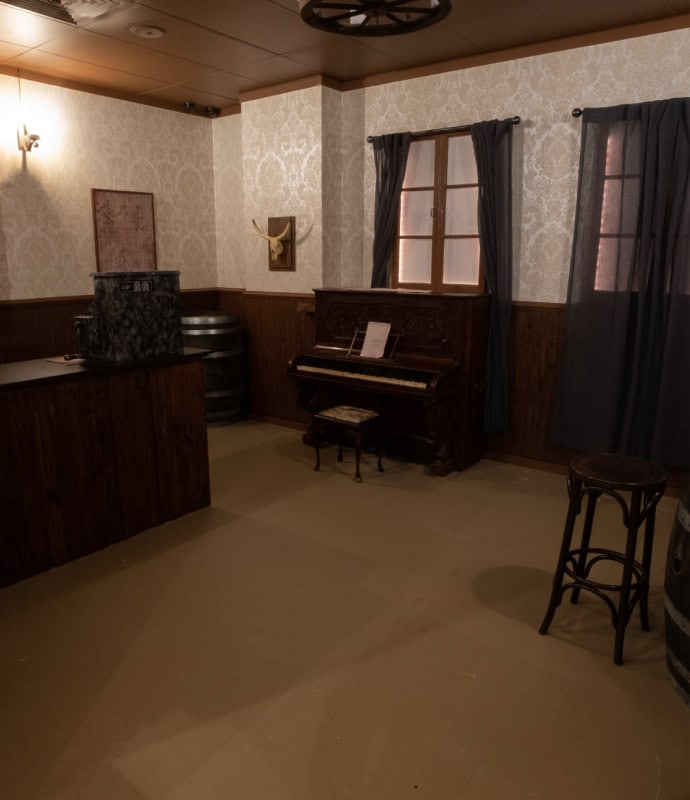 A room with a piano and a bar.