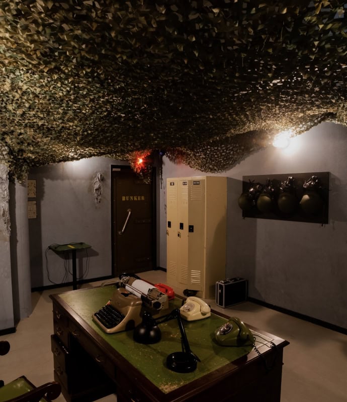 The room is decorated with camouflage netting.