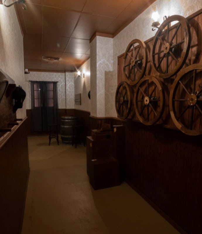 A hallway with wooden walls and wooden floors.