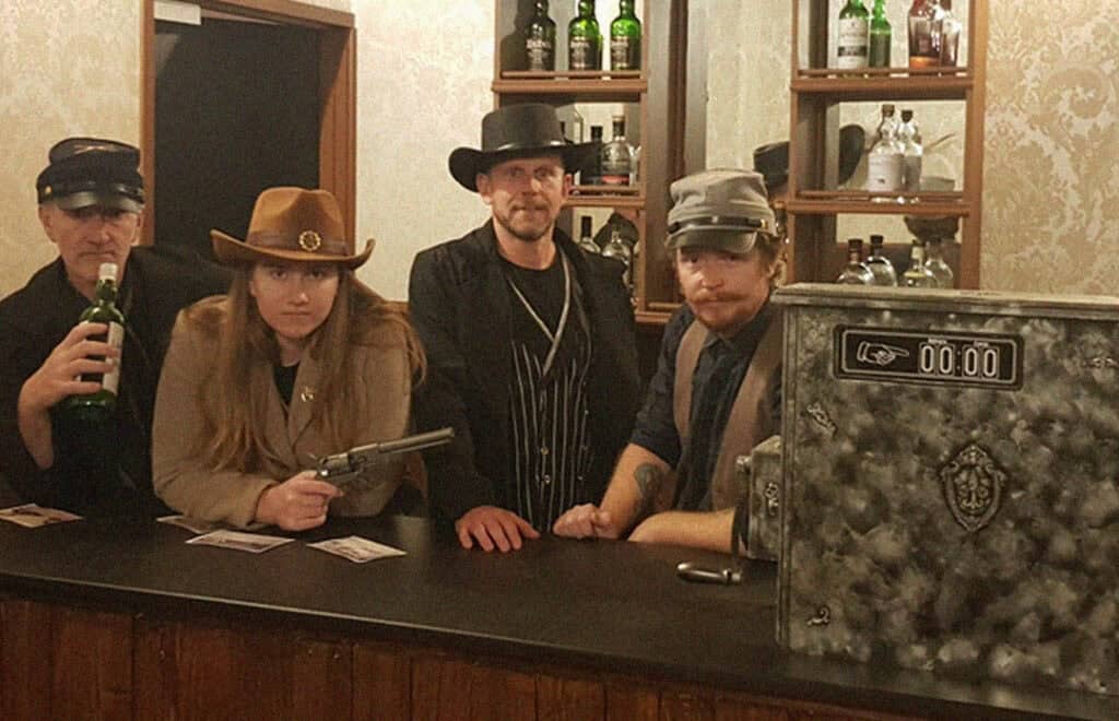 Fox in a Box Gold Coast Wild West Saloon escape room with vintage bar décor, cowboy hats, and rustic Western theme.