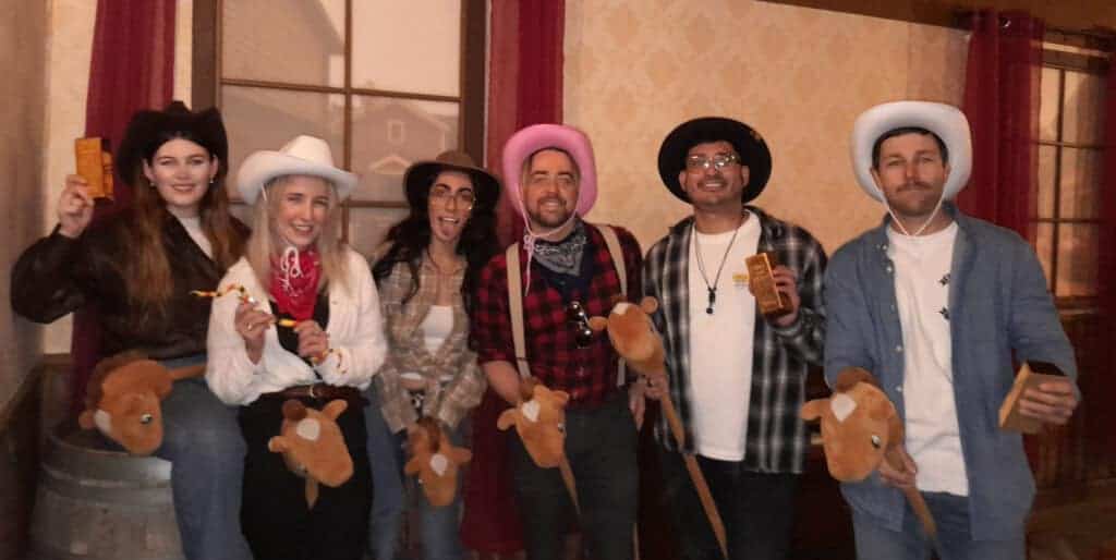 A group of people dressed in cowboy hats and holding guns.