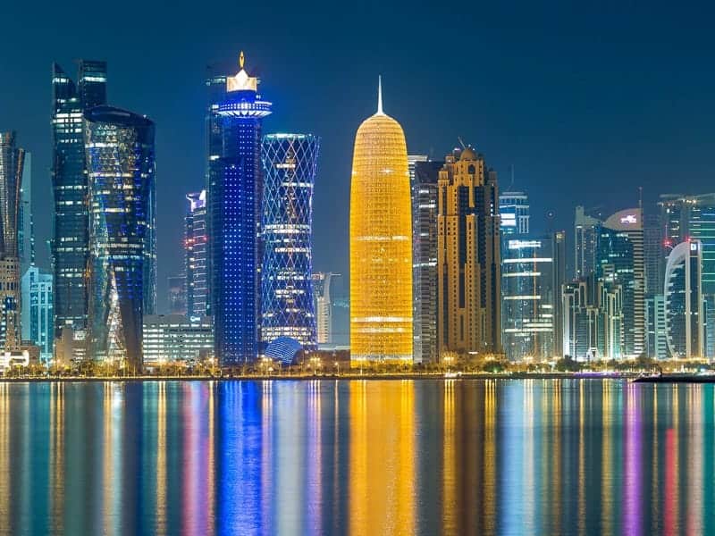 Skyline of Doha, with Doka Tower lit up in orange.