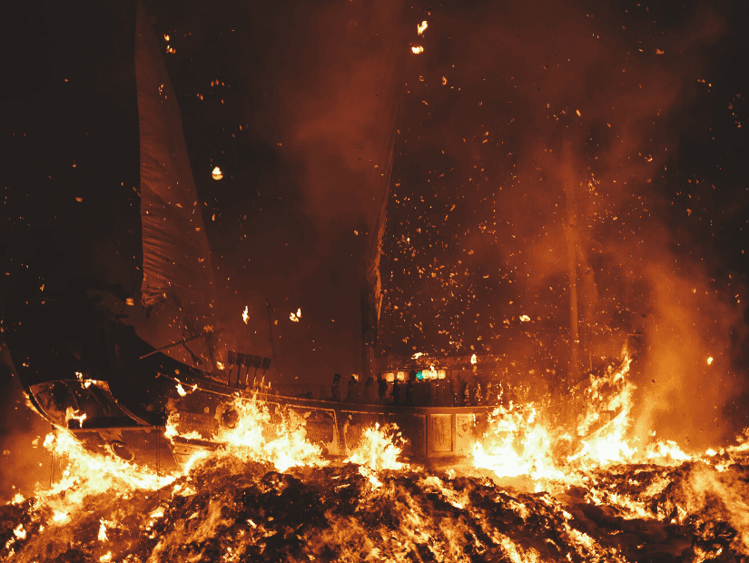 A large wooden boat being burned as part of a Taiwanese festival