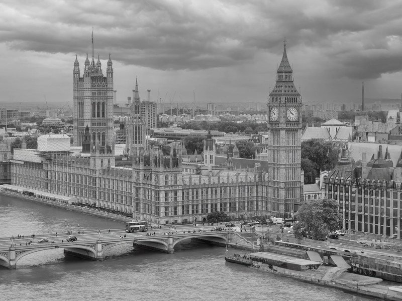 Monochrome aerial view of Big Ben and the Houses of Parliament over the River Thames in London.