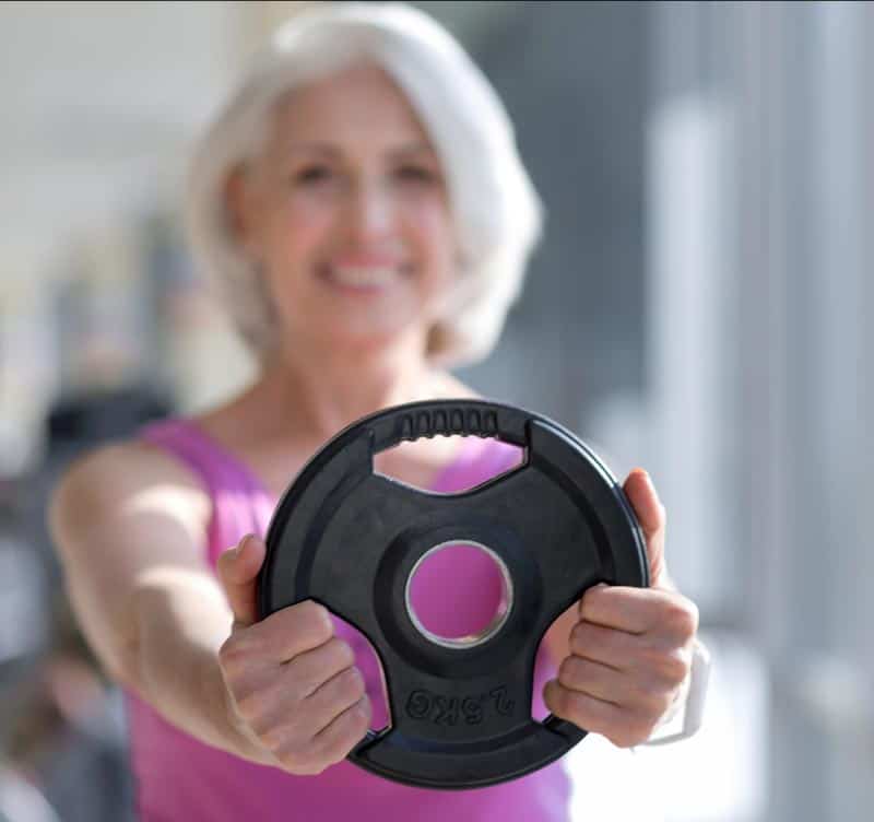Woman lifting weight in personal training workout