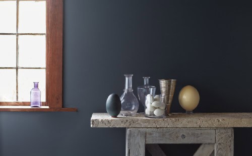 aura-blue-wall blue wall with wood table in front