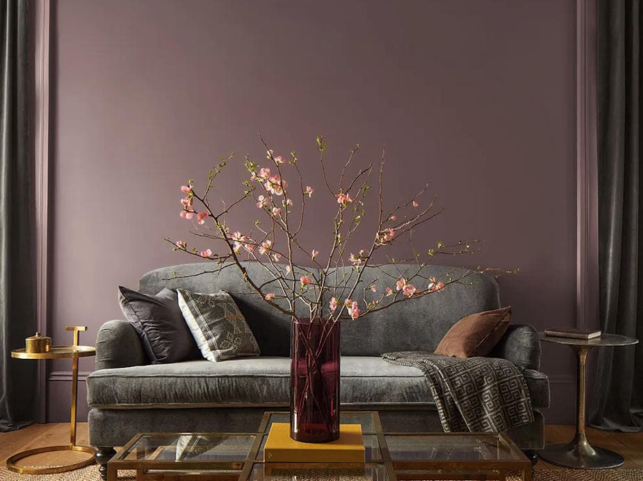 comfortable sofa and table in front of a wall that is painted with benjamin moore cinnamon slate colour