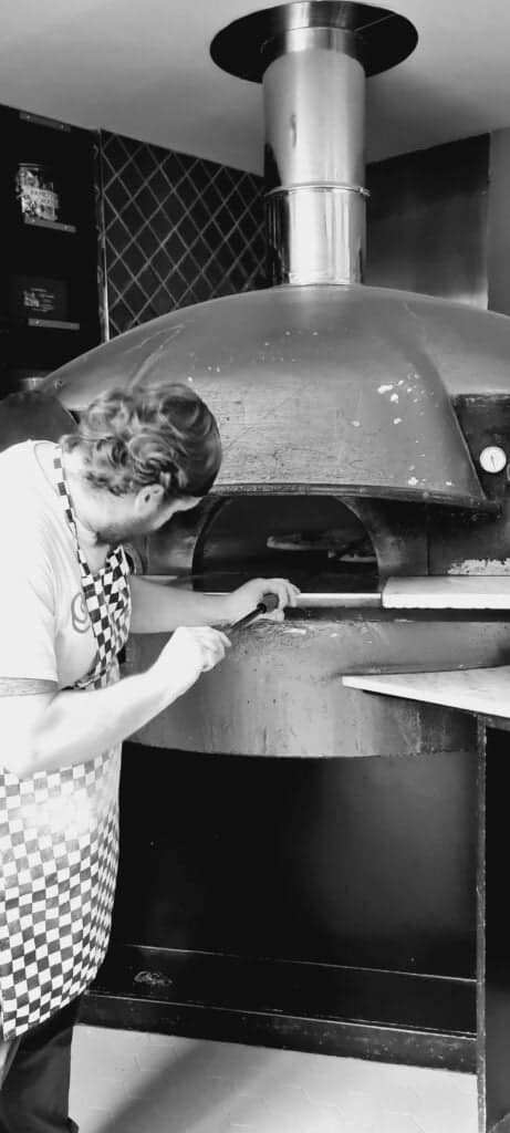 Horno pizzero de Sano Pizzeria siendo operado por el maestro pizzero