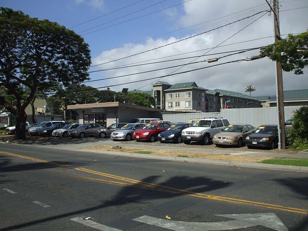 Commercial used automobile dealership displaying pre-owned vehicles on sales lot