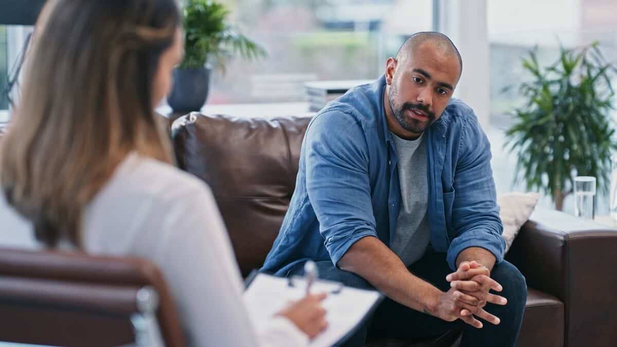 Man talking with his psychologist about mental health
