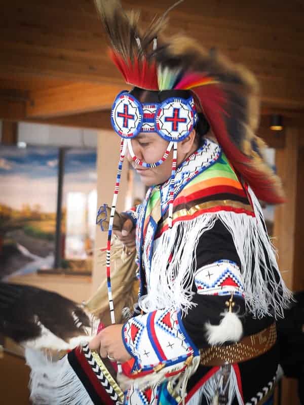 An indigenous performing dancing in regalia at Wanuskewin Centre
