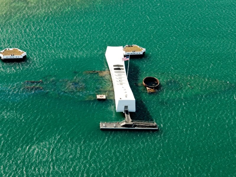 Aerial view of the sunken USS Arizon ship and a memorial structure above it.