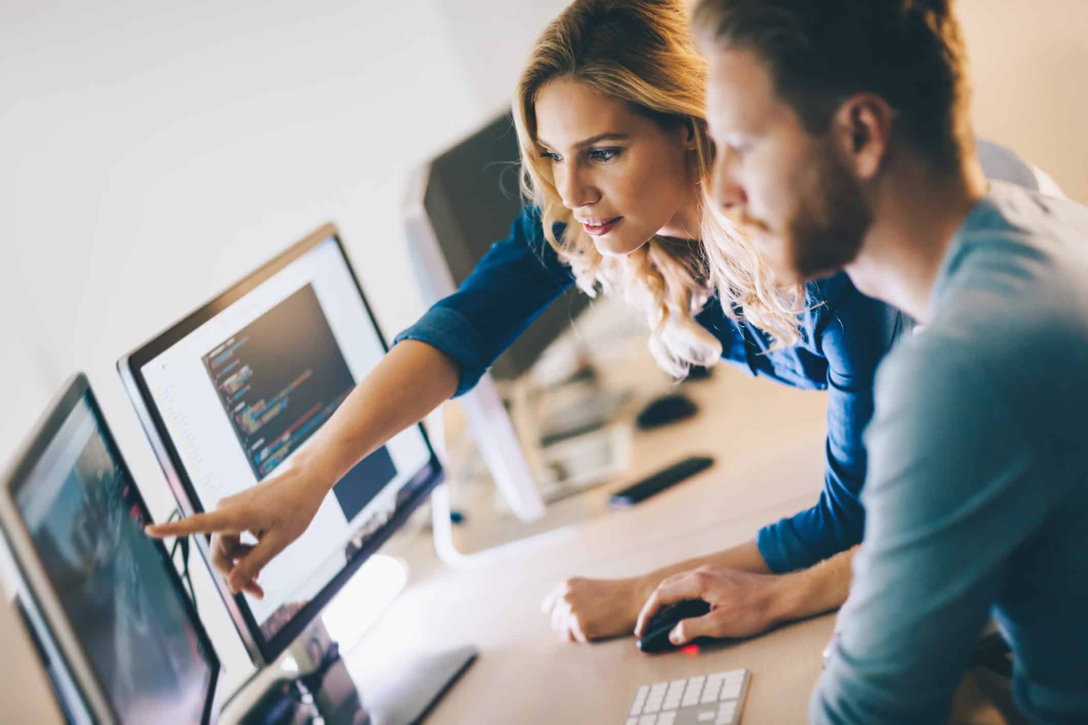 Two colleagues using modern working practices in the office 