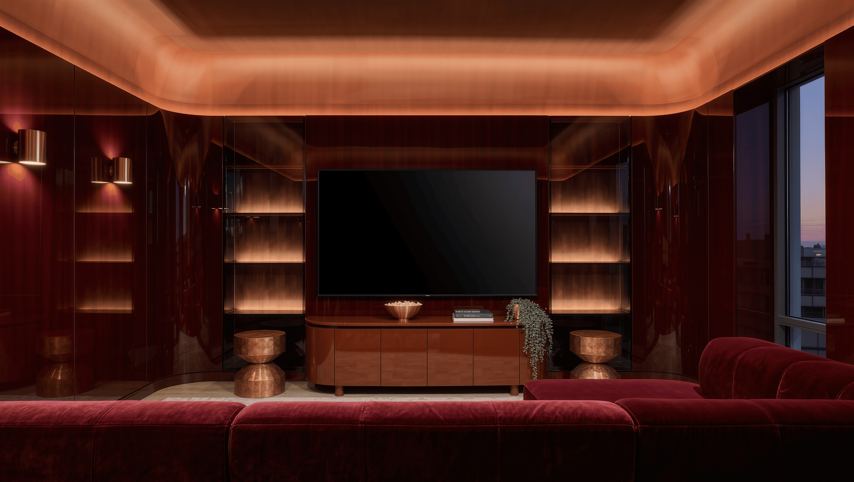 A dark polished media room with a cherry-red sectional, cola-brown lacquered console, copper sconces, and a warm ceiling light cove at dusk.