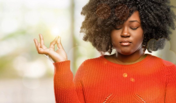 Woman meditating with eyes closed