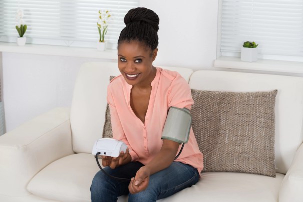 Woman taking her blood pressure at home