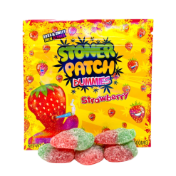 Close-up of Stoner Patch Gummies pack with colorful THC edibles on a wooden surface, branded with the Moonrock Online Shop logo.