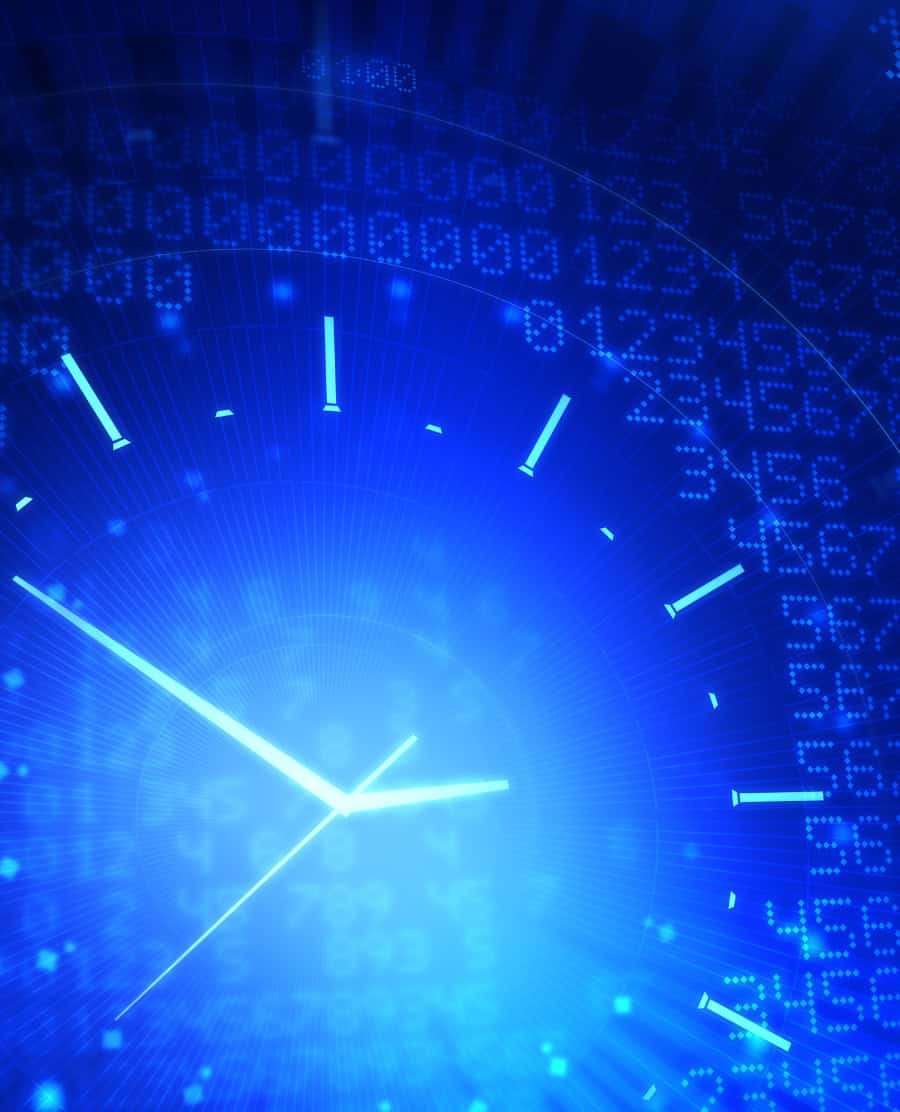 Abstract blue image showing bright clock hands and tick marks overlaid on rows of digital numbers, suggesting real‑time data and continuous monitoring.