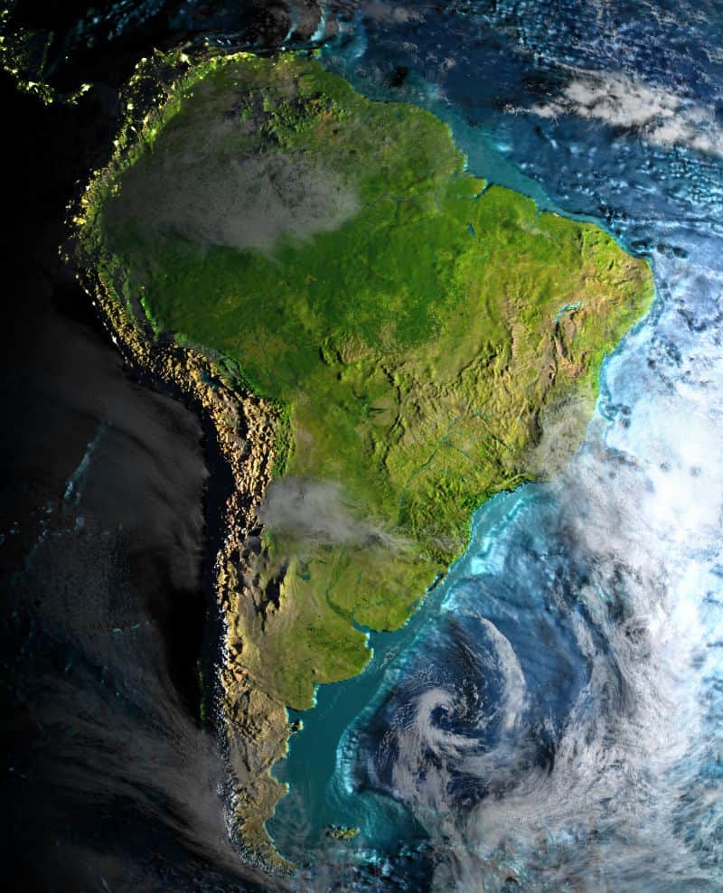 High‑resolution satellite image of the South American continent, showing coastlines, forests and mountain ranges surrounded by the Atlantic and Pacific Oceans.