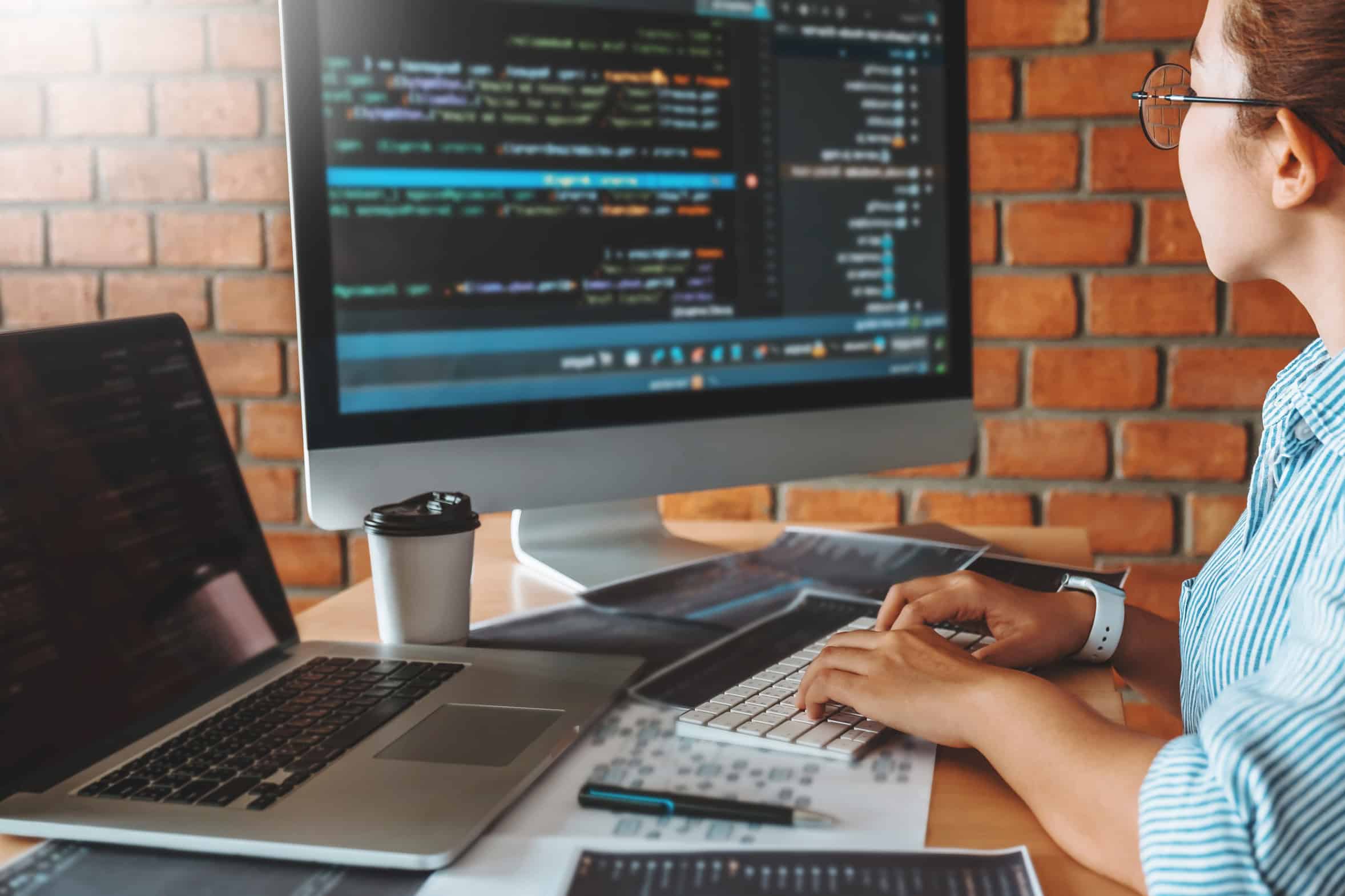 A software developer working at a desktop computer.
