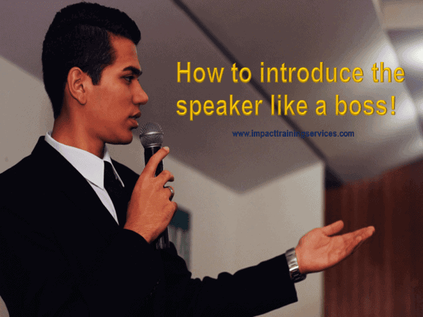 Image of man with microphone appearing to introduce a speaker