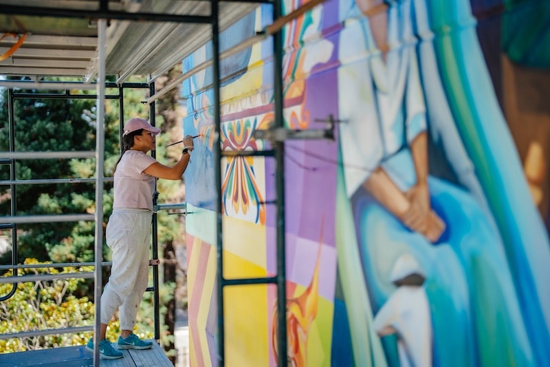 An artist painting a mural.