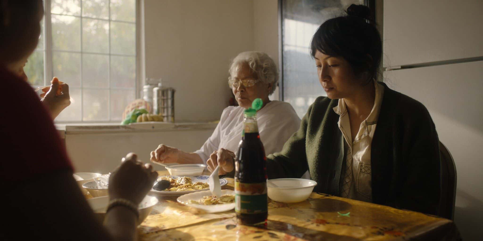 Nite Yun (right) eating with others at a table.