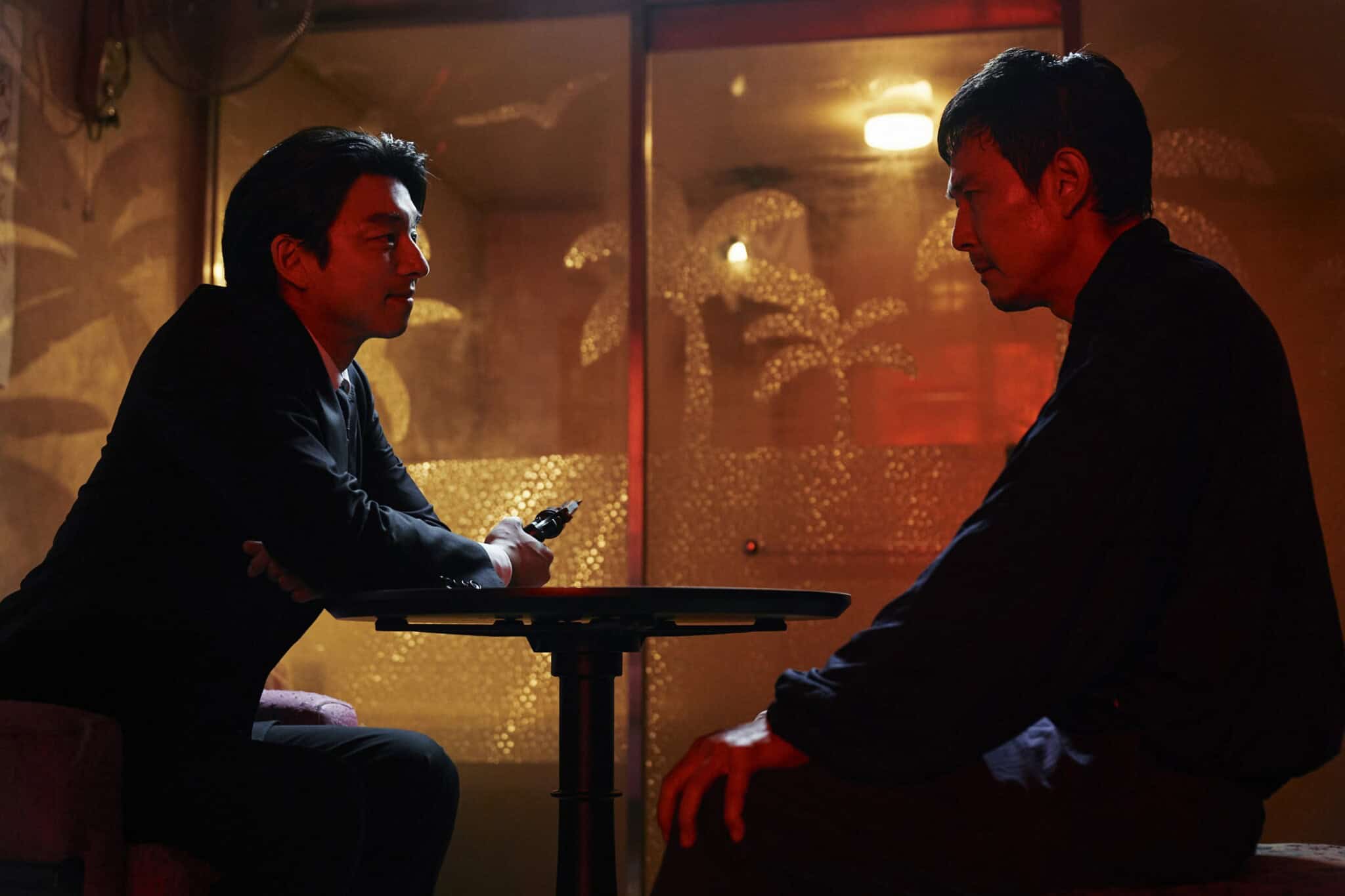 Gong Yoo and Lee Jung-jae sitting at a table.