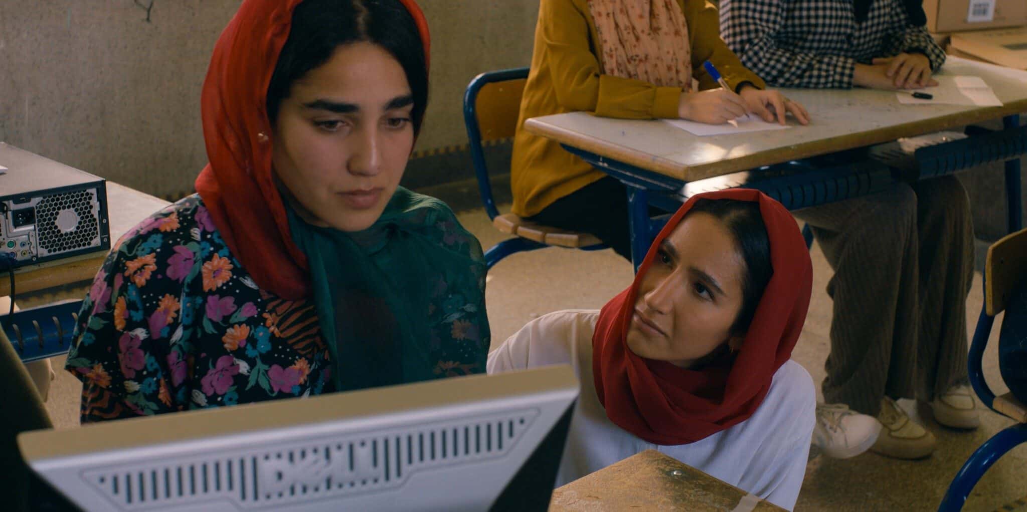 Still from "Rule Breakers"; Two women sit at a computer.
