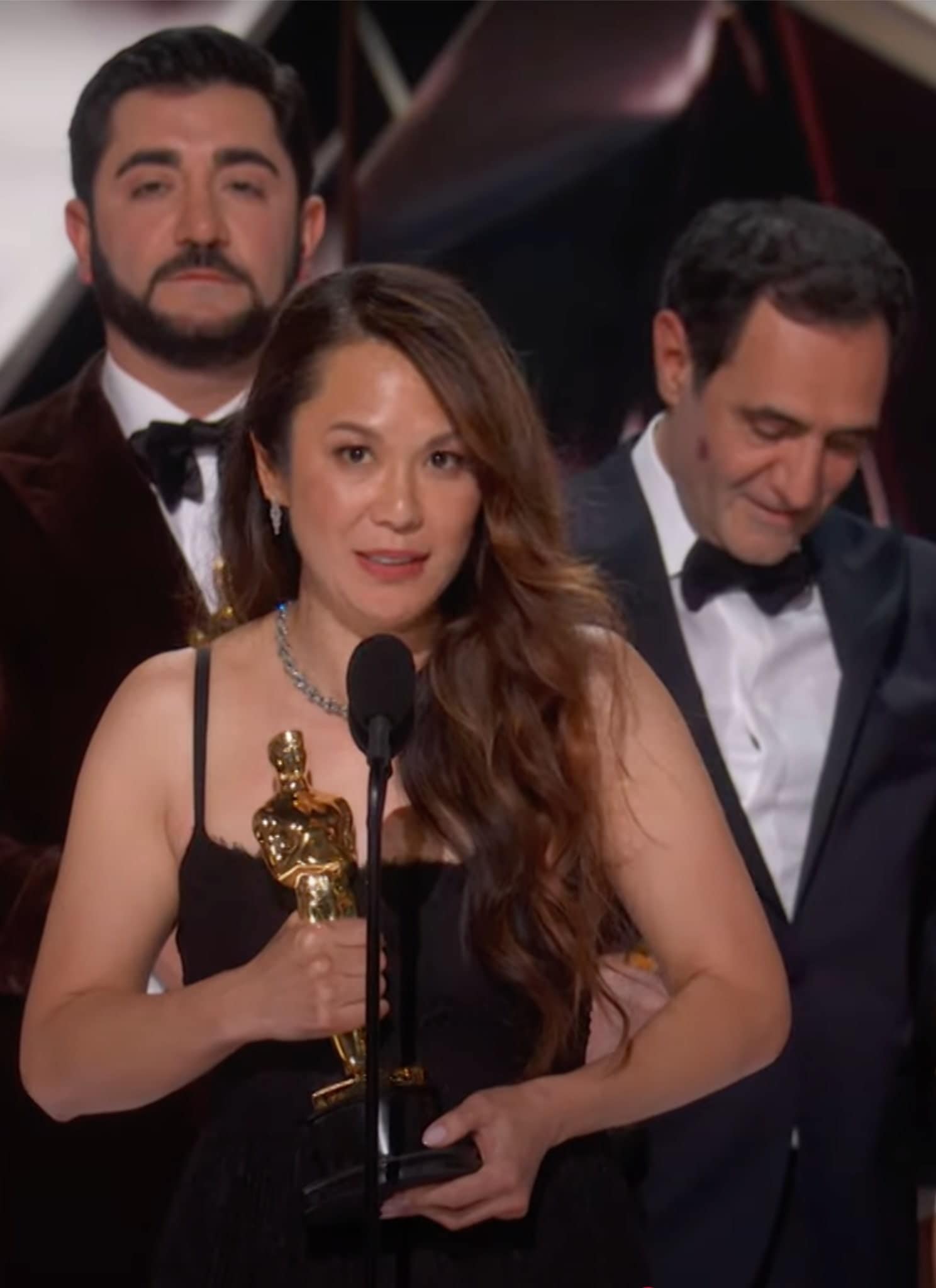 Samantha Quan and the cast and crew of Anora on stage at 97th Oscars.
