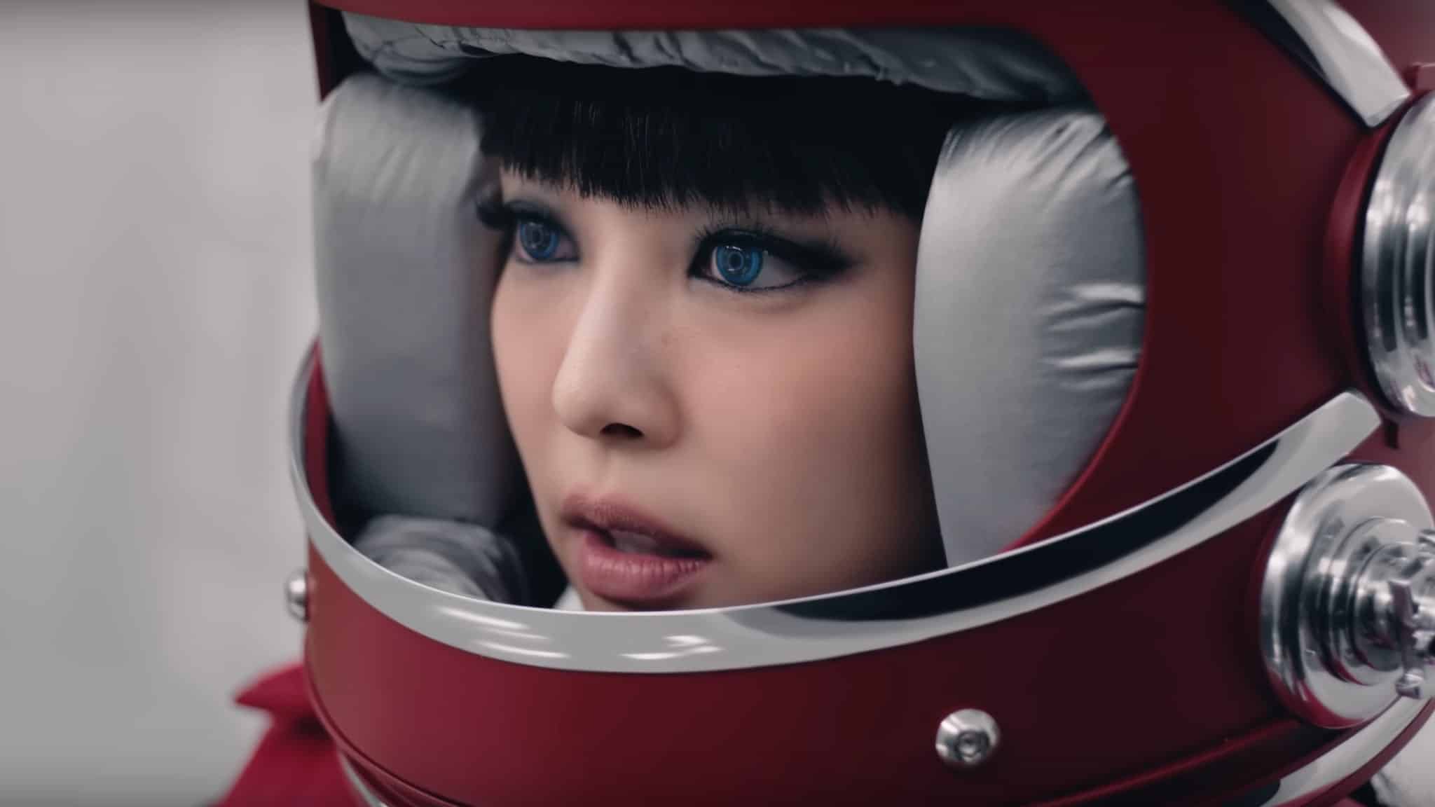Jennie Kim in red astronaut helmet with blue contacts.