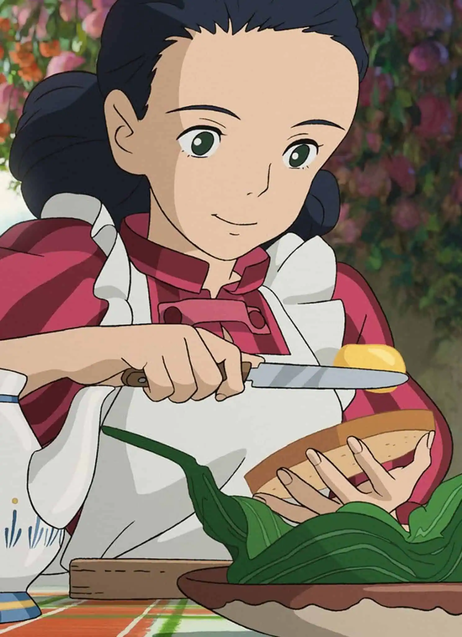 Still from "The Boy and the Heron"; A woman spreads butter on bread.