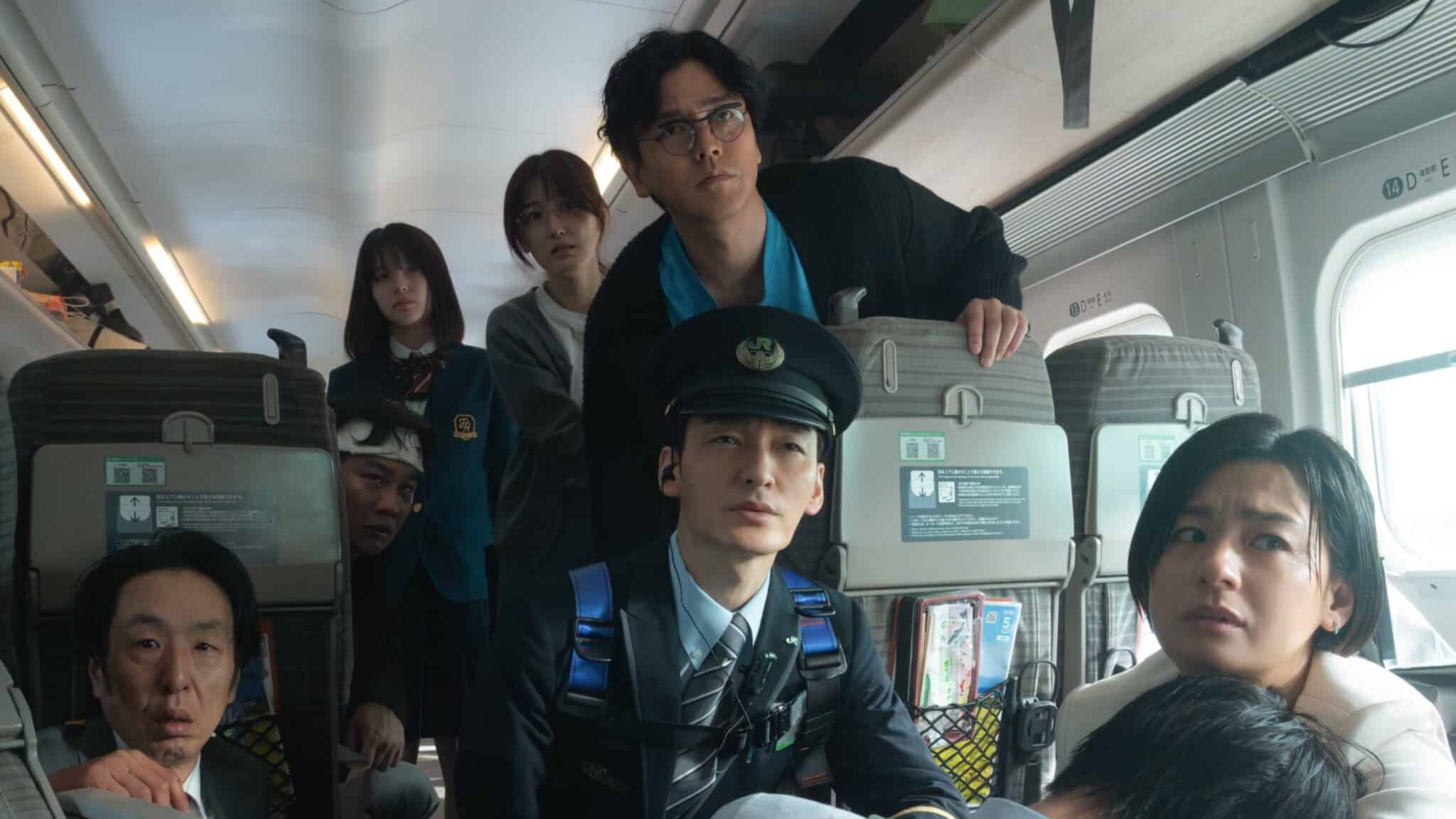 Still from "Bullet Train Explosion" showing several people sitting in a train.
