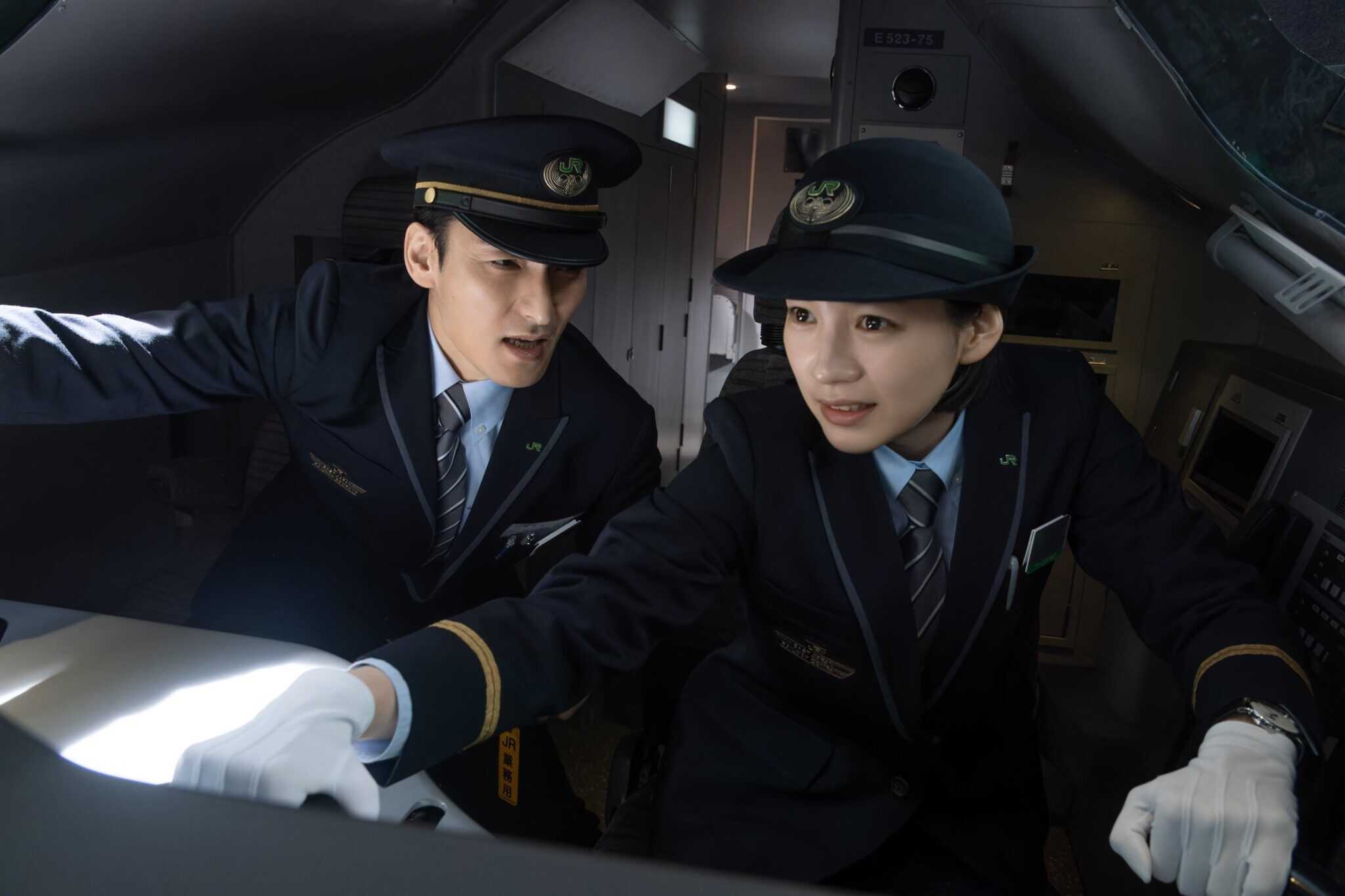 Still from "Bullet Train Explosion" showing two train conductors.