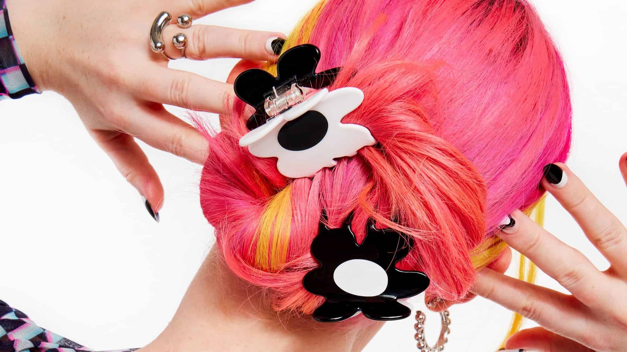 Pink-haired person wearing Chunks hair clips.