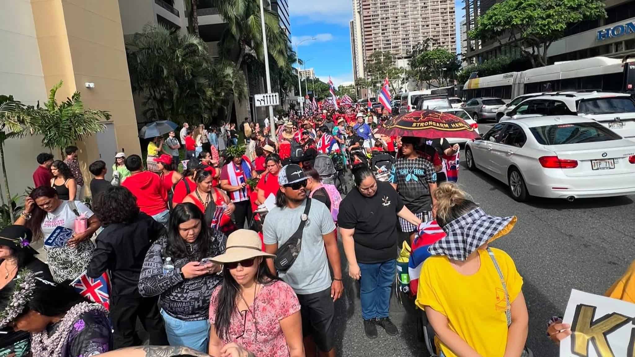A group of Native Hawaiians on the street protesting.
