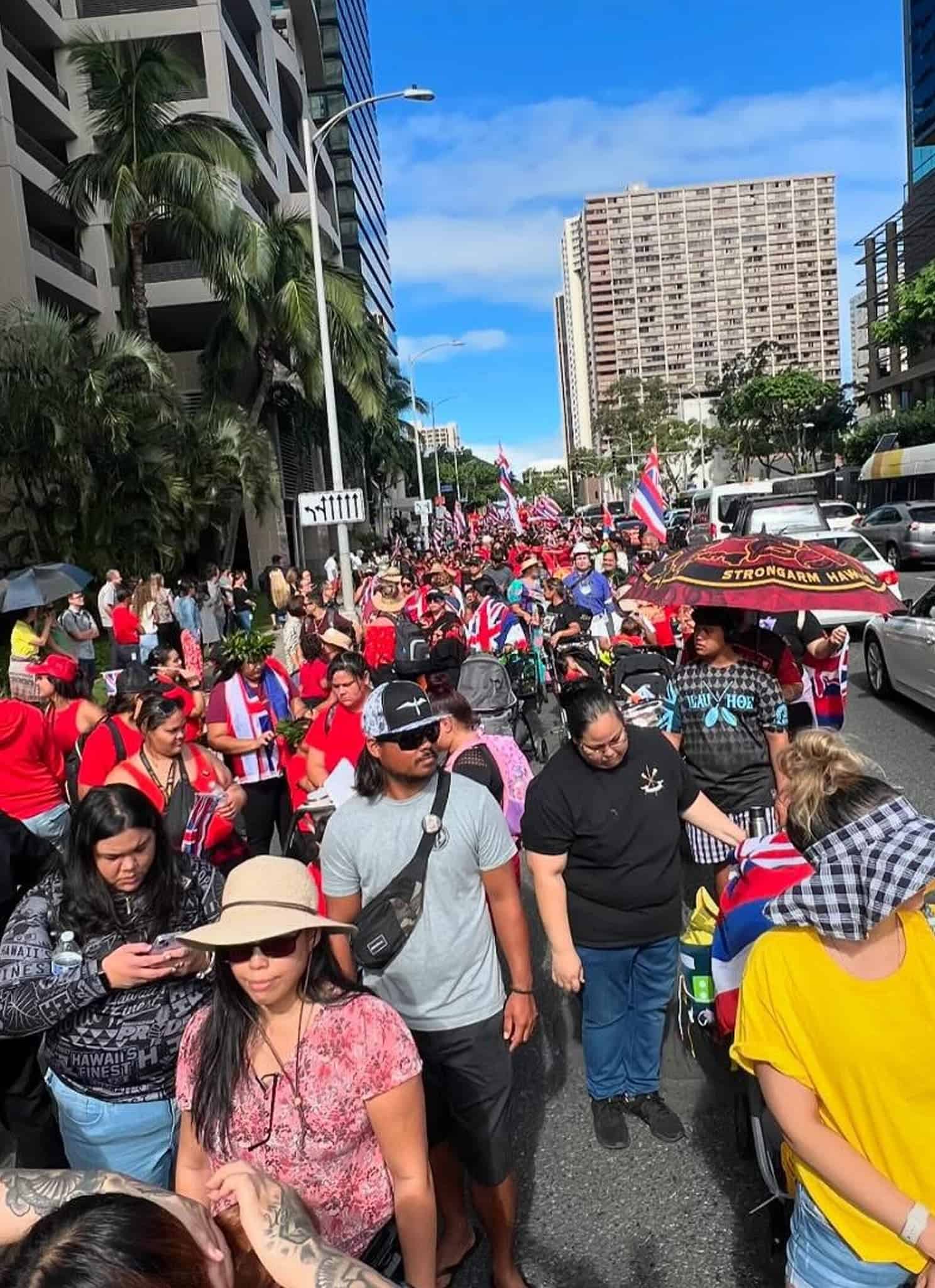 A group of Native Hawaiians on the street protesting.