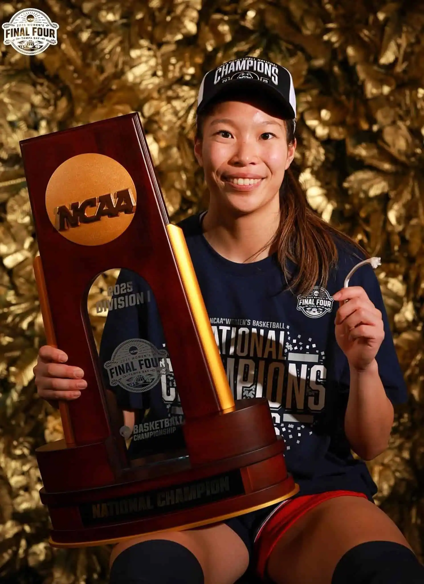 Kaitlyn Chen holding NCAA trophy.