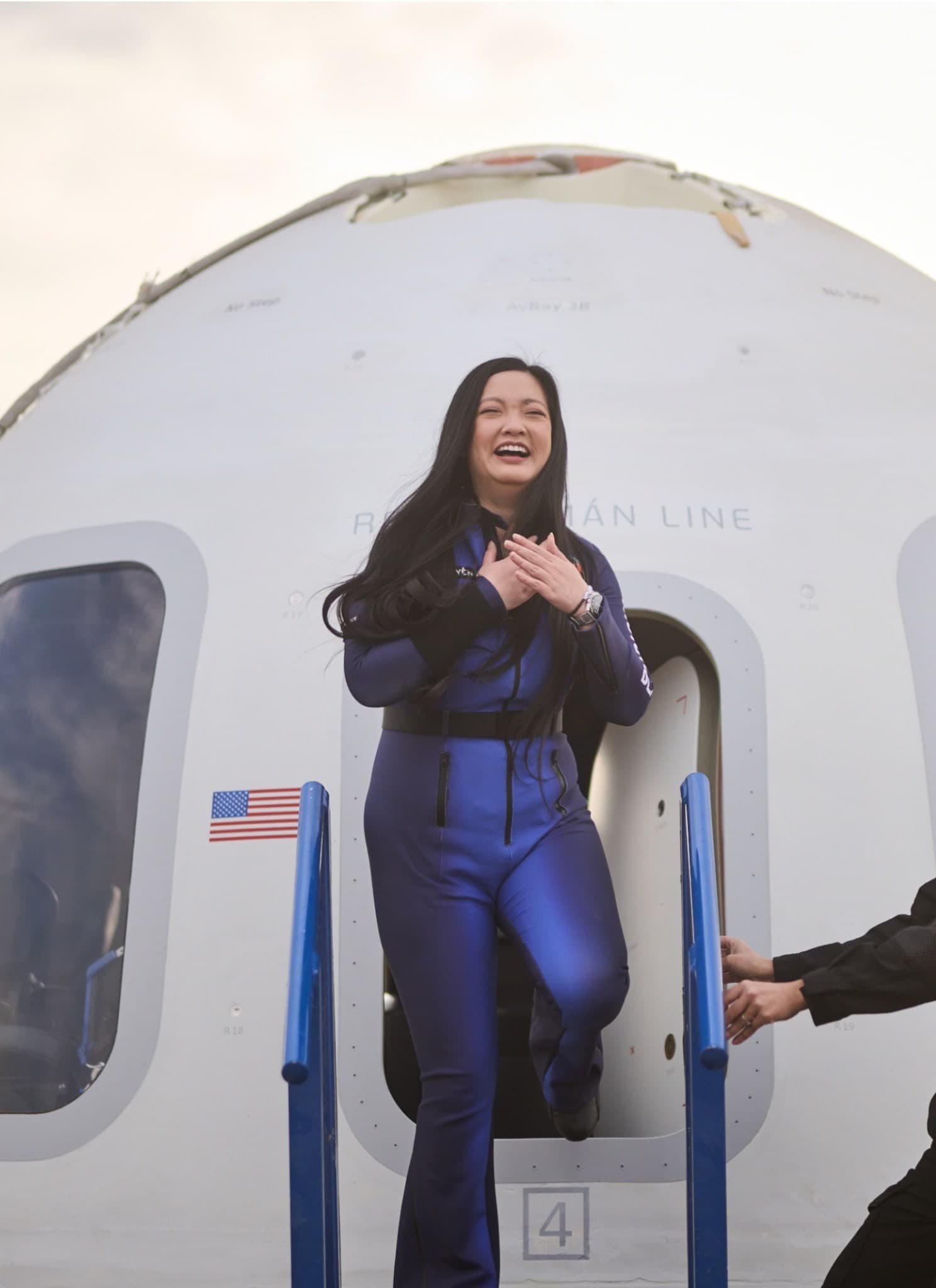 Amanda Nguyen in blue origin space suit landing.